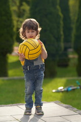 little boy playing with a ball