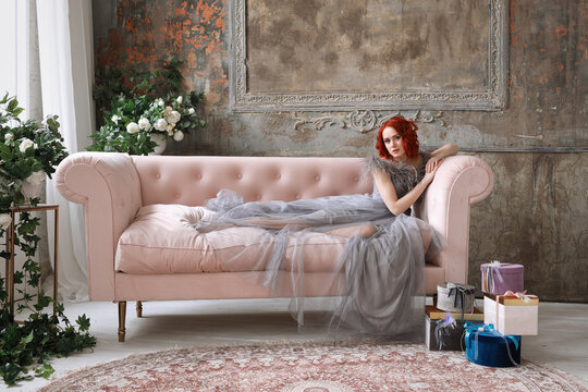 Beautiful girl with red hair in a long gray dress - Powered by Adobe