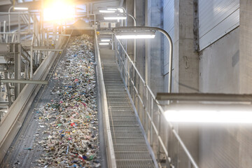 RDF fuel production line with municipal waste on a conveyor belt in Waste-to-Energy plant. Ideal for: recycling, sustainable energy, waste management, environmental protection.