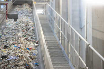 RDF fuel production line with municipal waste on a conveyor belt in Waste-to-Energy plant. Ideal for: recycling, sustainable energy, waste management, environmental protection.
