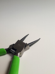 Snap ring pliers isolated on a white background, these pliers are used to clamp or release snap rings or circlips, components that function as locks or retainers.