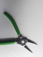 Snap ring pliers isolated on a white background, these pliers are used to clamp or release snap rings or circlips, components that function as locks or retainers.
