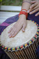 Sao Paulo, SP, Brazil - June 2 2025: Hands of Caucasian woman playing djembe drum.