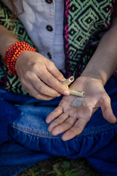 Sao Paulo, SP, Brazil - June 2 2025: Close up of Caucasian woman's hands holding kuripe and snuff for self-administration, medicines from the Amazon rainforest.