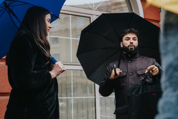 A discussion between individuals outdoors, sheltered by umbrellas during a rainy day, exchanging...
