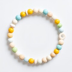Pastel toned circular wooden beads arranged in a decorative pattern on white background