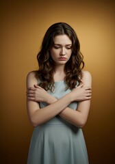 A young woman holding her own arm, symbolizing loneliness