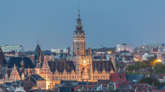 Aerial view of Schaerbeek Town Hall day to night transition timelapse in Brussels, Belgium. Neo-Renaissance architecture surrounded by illuminated red-roofed houses. Cityscape and historical charm