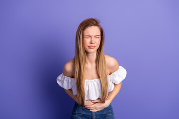 Young woman in stylish white top posing on vibrant background expressing emotions in cheerful...