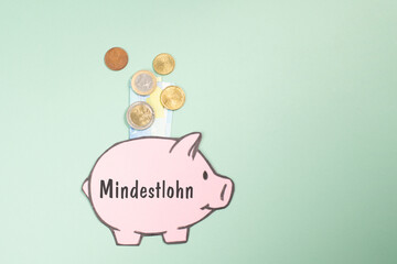 Minimum wage, piggy bank with Euro money banknote, inflation, high living costs, increase of rent, grocery, gas and electricity price, economics and financial crisis