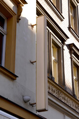 Empty vertical blank white billboard on building facade with architectural details. The billboard...