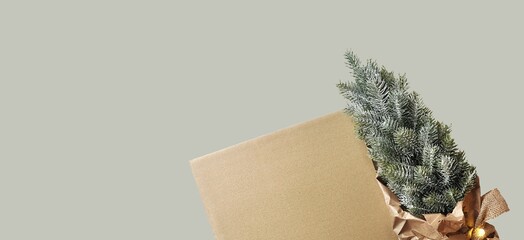 Christmas card without text. Blank cardboard sheet, artificial Christmas tree, paper decorations. Wrapping gifts. Gray background. Sustainable Christmas. Place for text, negative space