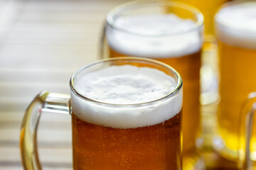 Mugs of light beer in a glass on the table
