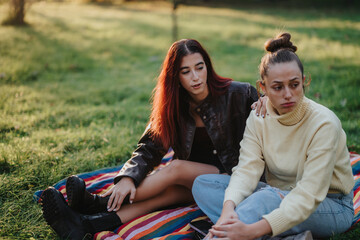 A supportive moment between two friends, one consoling the other during an emotional conversation...