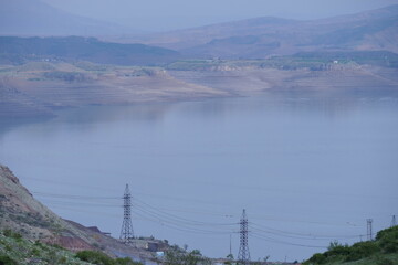 View of the river and mountains in the distance. Light fog. Blue background.