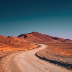 Naklejka premium Dusty road winding through a desert landscape