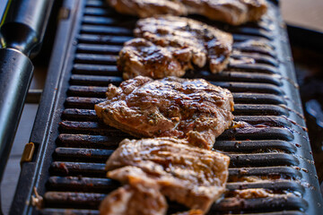 Pork steak being grilled on an electric grill, close-up