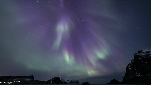 Full-sky auroras at Haukland Beach in Lofoten, Norway - tilt down