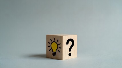 Concept of finding a solution is depicted by the wooden cube with lightbulb and question mark symbols, a visual metaphor for innovation, brainstorming, and creative problem solving.