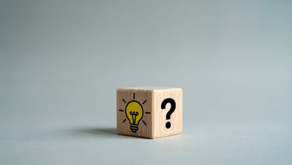 A light bulb idea and question mark are shown on a wooden block, representing innovation, problem-solving, solutions, and brainstorming in business and creative projects.