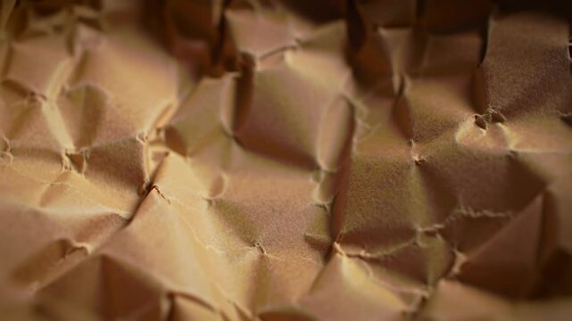 Close-up view of brown wrinkled paper with many visible creases
