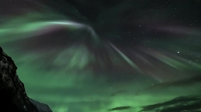 Aurora borealis above a snowy mountains. tilt up