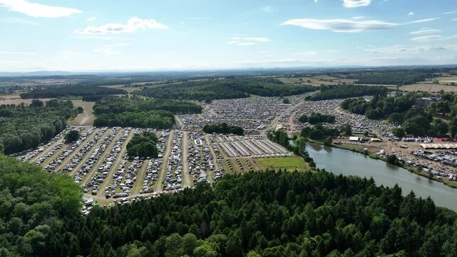 Large-Scale Event Setup with Glamping Rows and Parked Cars