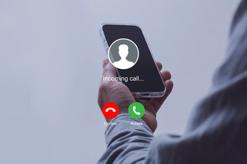 Notification of an incoming call on a smartphone held by a man wearing a shirt. Concept of mobile communication, telecommunication and incoming call notification.