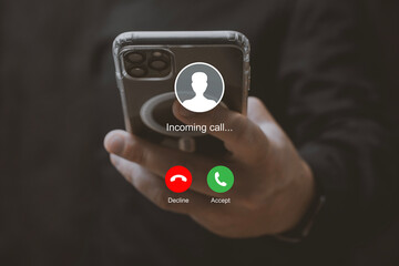Man holding smartphone with incoming call interface screen. Close-up of hands holding mobile phone with call accept and decline buttons on display.