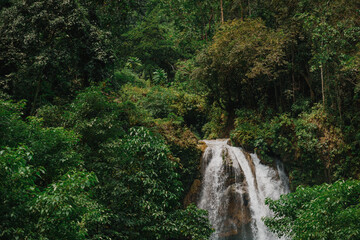 Close Scenic Wide View of Kawasan Falls Jungle Waterfall and Turquoise River in Cebu, Philippines