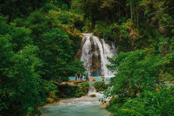 Close Scenic Wide View of Kawasan Falls Jungle Waterfall and Turquoise River in Cebu, Philippines
