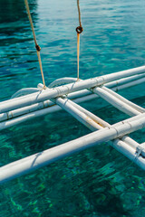 Close-Up of wooden Bangka Outriggers boat in Motion in blue water Sea in Philippines
