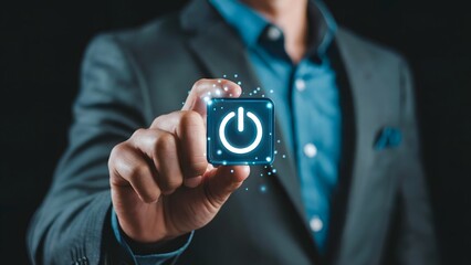 A suited professional showcases a glowing power button, symbolizing concepts such as technology, startup innovation, and decision making for a new digital project.