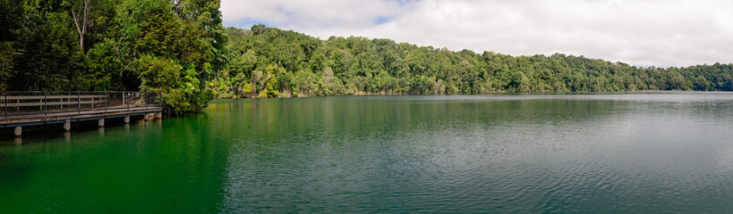 Lake Eacham, volcanic lake in Atherton Tablelands, North Queensland, panorama including walking track boardwalk