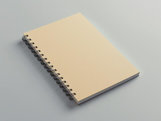 A blank spiral notebook mockup with front cover up, placed on soft light gray background, top-down view, minimal composition for stationery or education branding.