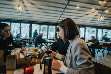 A group of business professionals engaged in a meeting at a modern cafe setting, exchanging ideas and reviewing important documents, illustrating professional communication in a casual environment.
