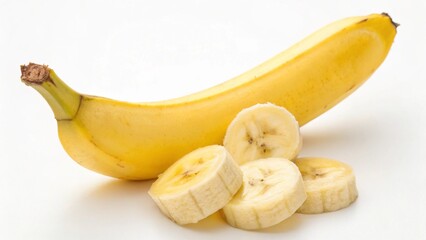 A ripe yellow banana with several slices isolated on white background