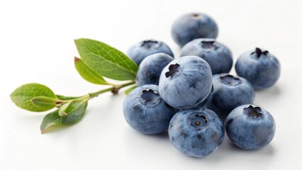 A pile of fresh blueberries with green leaves isolated on white background