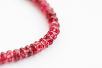 Red Spinel Faceted Rondelle Beads on White Background

