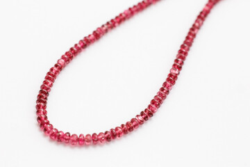 Red Spinel Faceted Rondelle Beads on White Background

