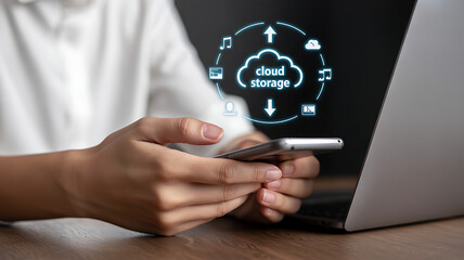 Person using smartphone and laptop with cloud storage technology interface displayed
