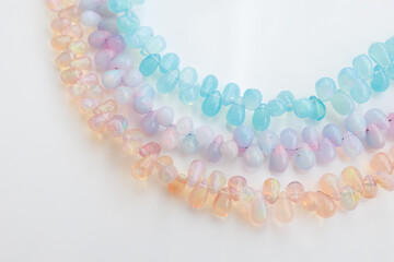 Colorful Opal Beads in Soft Pastel Shades on White Background

