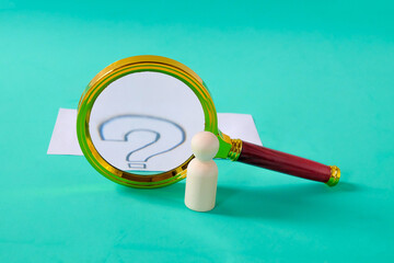 A magnifying glass with question mark signs inside.