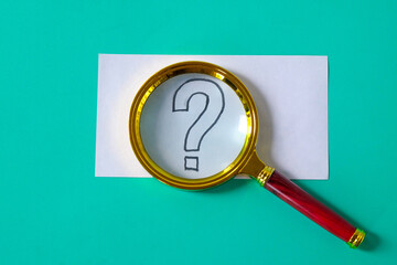A magnifying glass with question mark signs inside.