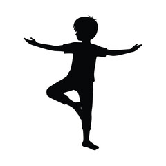 Black silhouette of a young boy balancing on one leg with arms outstretched child