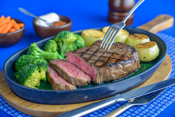 Grilled Steak with Vegetables on Sizzle Plate