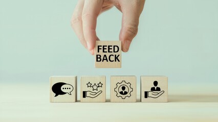 Hand places wooden block labeled Feedback over other blocks with icons