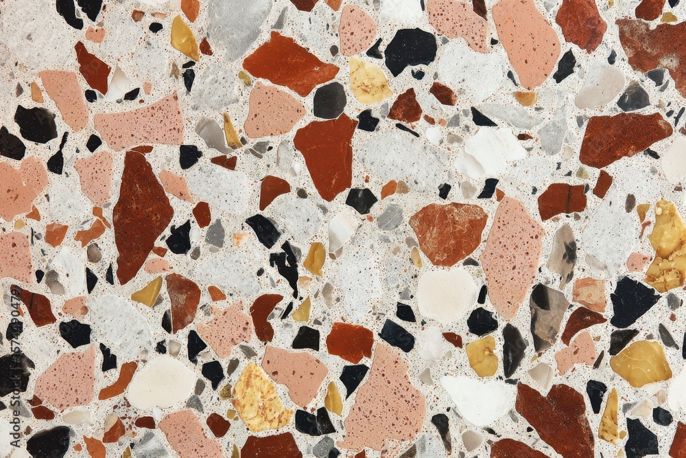 Poster terrazzo texture with irregular shapes of varied colors embedded in a pale matrix
