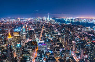 USA, New York, New York City, Manhattan, Aerial view of illuminated skyline at night.
