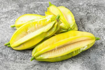Unique green fruits displayed on a textured surface highlight freshness and culinary potential